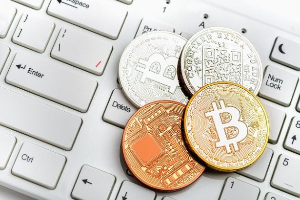 Bitcoin coin on white keyboard