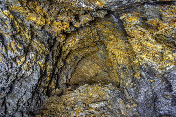Golden rock in the old mine