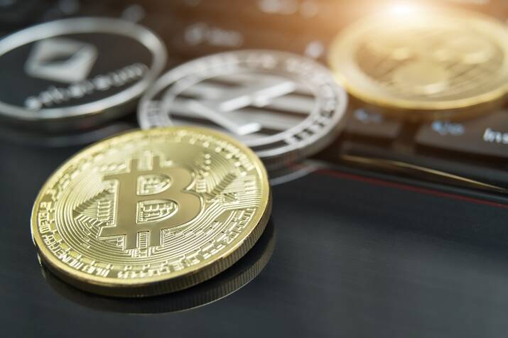 cryptocurrency coins – Litecoin, Bitcoin, Ethereum, Ripple cryptocurrency concept stock of physical bitcoins gold and silver coins