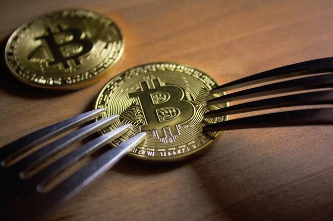 Two forks rest near bitcoin coin