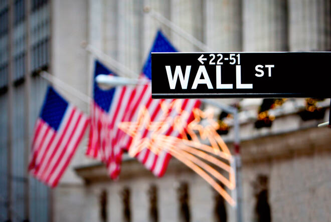 Sign of Wall Street with flags in the background