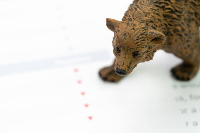 Investment bear market concept, bear figure standing on financial report with red arrow pointing dow as price going down, low buy and high sell volume in stock or equity exchange market