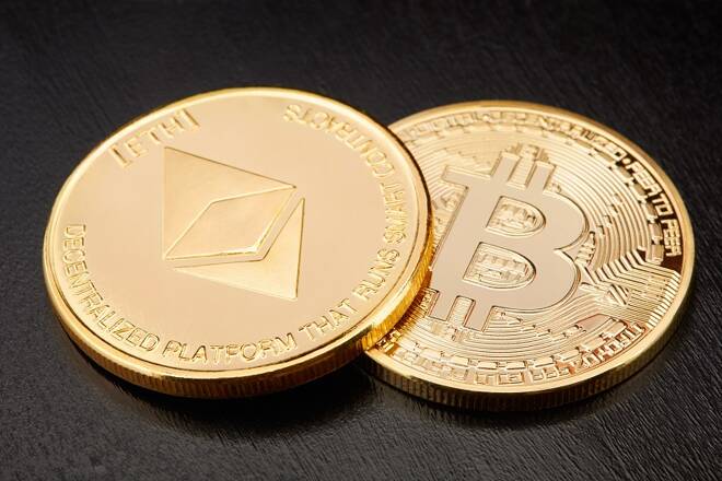 Ethereum and Bitcoin, two golden cryptocurrency coins on black background