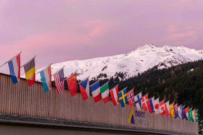 the congress center in Davos with flags of nations at sunrise du