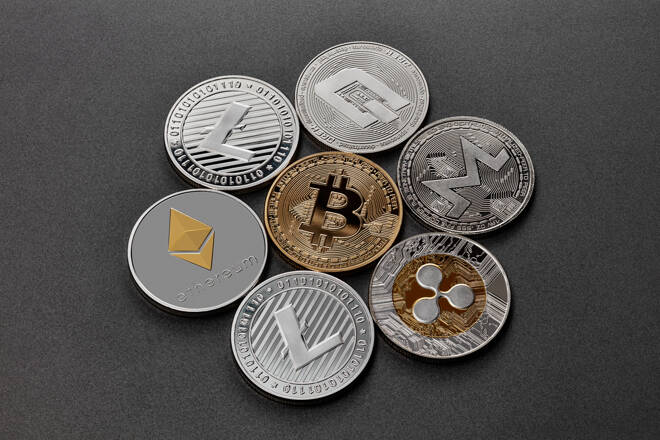 Coins of crypto currency are presented on a dark background. Virtual money concept.