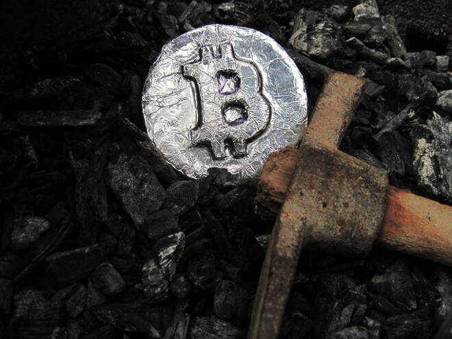 Bitcoin mining. A mine with real hardware. Symbols of block chain technology for crypto currency ? metal coin, coal, pickaxe