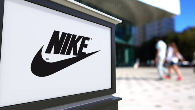 Street signage board with Nike inscription and logo. Blurred office center and walking people background. Editorial 3D rendering United States