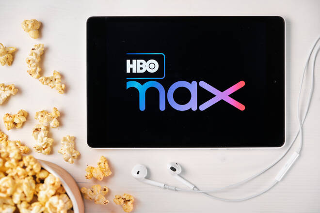 HBO MAX logo on the screen of the tablet laying on the white table and sprinkled popcorn on it. Apple earphones near the tablet , August 2020, San Francisco, USA.