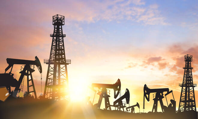 Oil pumps and derricks over sunset background. Vector illustration.
