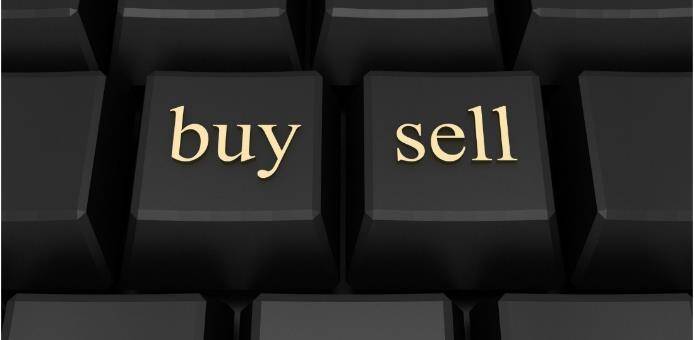 Gold printed buy and sell text on black computer keys