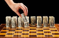 Money strategies concept - dollar bills on chess board manipulated by woman hand