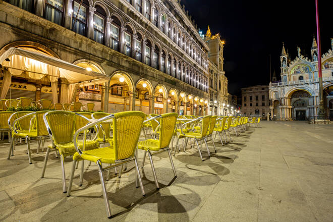 Night view of one Bar on the Piazza San Marco showing a multitude of empty chairs and empty square