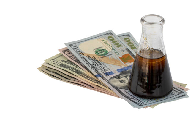oil prices down. flask of oil and money isolated on a white background.