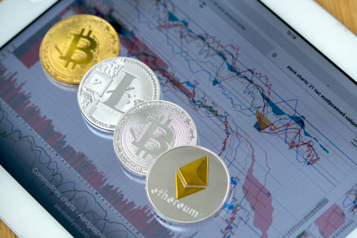 E-coins on tablet computer with charts on screen