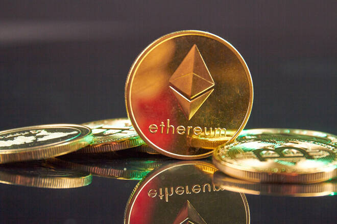 Close-up golden ethereum cryptocurrency coin on the reflective surface. fxempire