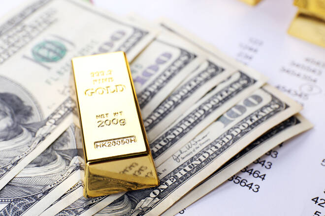 Gold bullion with money on table close up fxempire