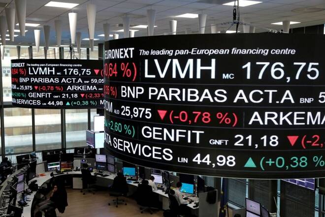 Company stock price information, including that for LVMH Moet Hennessy Louis Vuitton SA, is displayed on screens as they hang above the Paris stock exchange, operated by Euronext NV, in La Defense business district in Paris