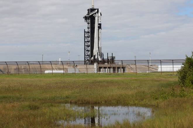 A SpaceX Falcon 9 rocket stands on the launch pad as it is prepared for launch to the International Space Station at the Kennedy Space Center in Cape Canaveral