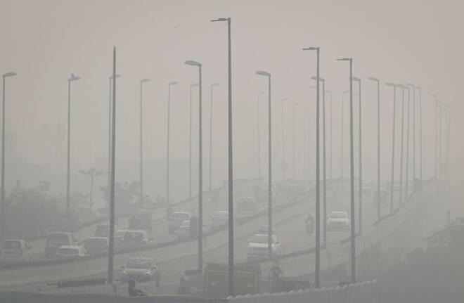 Traffic moves on a flyover on a smoggy morning in New Delhi
