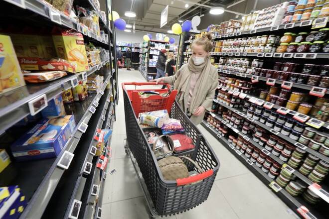 A woman pushes a shopping trolley as she shops in a supermarket at CAP3000 shopping mall in Saint-Laurent-du-Var