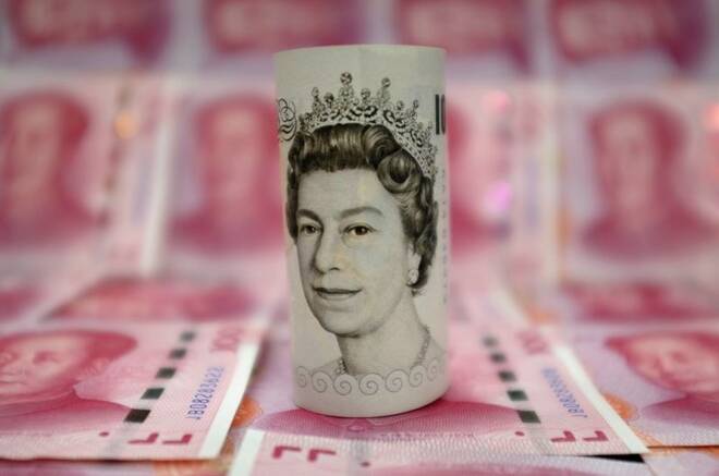 A British 10-pound banknote and Chinese 100-yuan banknotes are seen in a picture illustration, in Beijing
