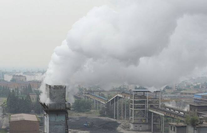 Smoke billows from a chimney at a coking factory in Hefei