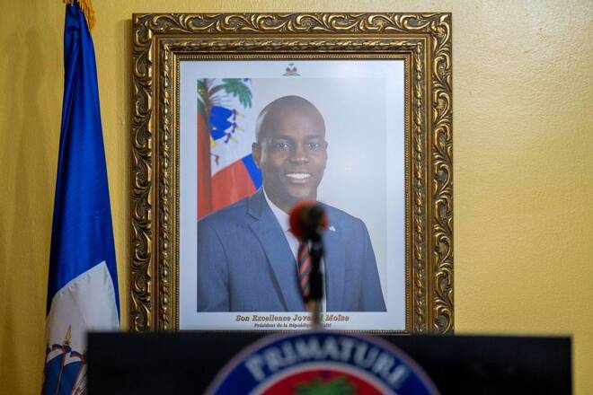A picture of the late Haitian President Jovenel Moise hangs on a wall before a news conference