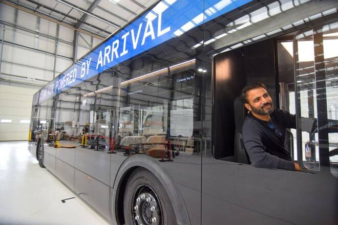 Avinash Rugoobur, president of electric van and bus maker Arrival, shows off the startup's pre-production electric bus model at the company's research and development centre in Banbury