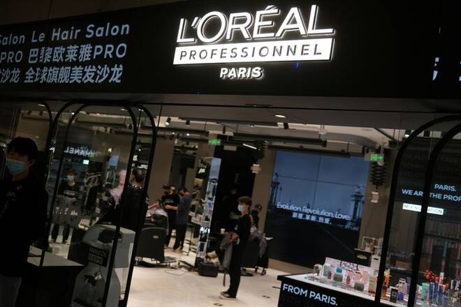 Staff members work at a hair salon of L’Oreal in Beijing