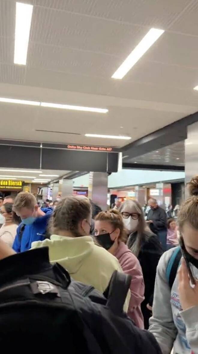 People gather to leave Hartsfield-Jackson Atlanta International Airport after reported shooting, in Atlanta