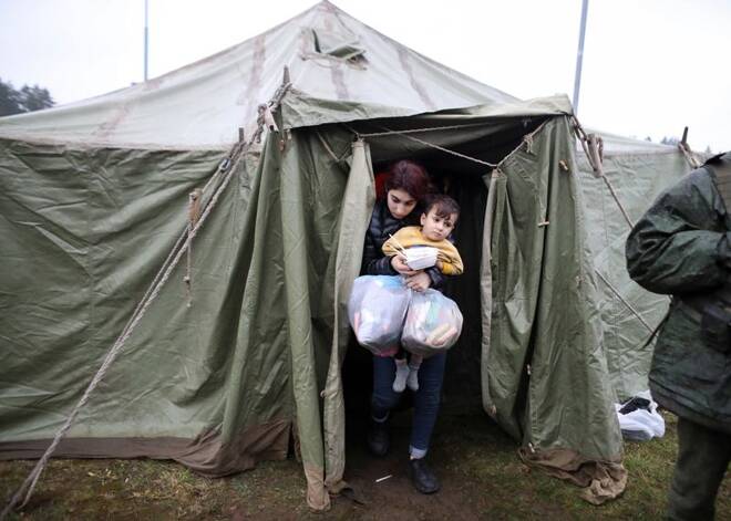 Migrants receive food near the Belarusian-Polish border in the Grodno region