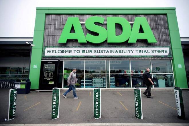 Shoppers walk past the UK supermarket Asda in Leeds, Britain