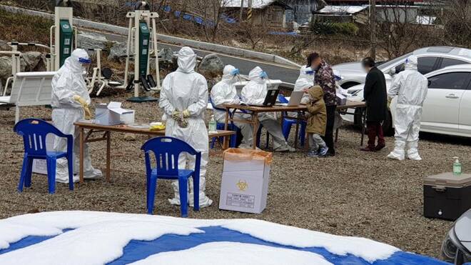 Residents in a religious community arrive to undergo COVID-19 test in Cheonan