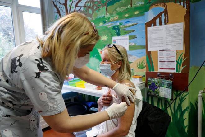 A nurse gives a dose of the Pfizer-BioNTech vaccine to a patient at the Bethesda Children's Hospital in Budapest