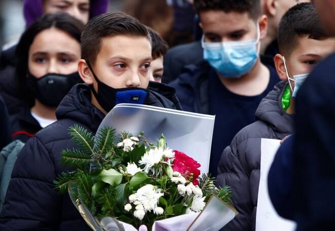 Pupils of the elementary school Ismail Qemali react as they pay their respect to six of their friends and other victims of the bus crash in Bulgaria