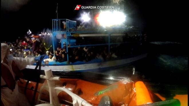 Italian coastguard rescue migrants from boat in distress in the Mediterranean Sea