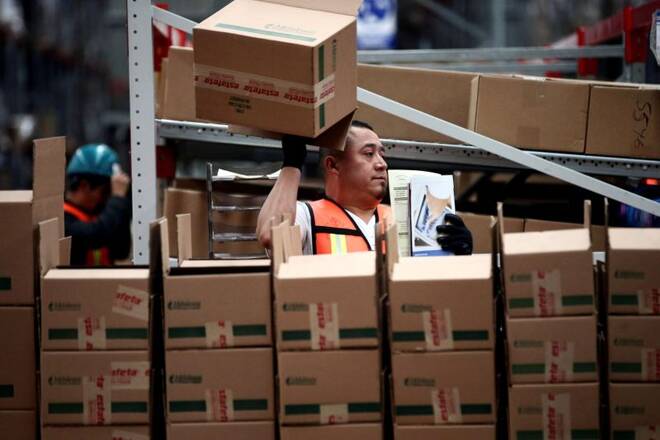 An employee of Estafeta Mexicana holds a box as he works at the company's logistics centre in Mexico City