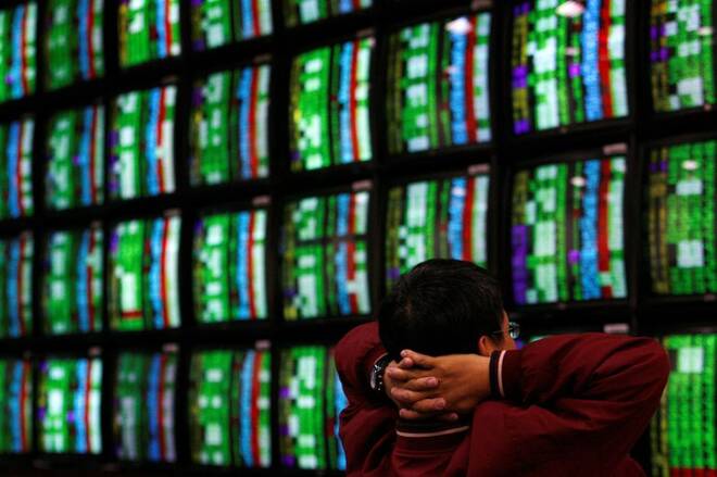 A man looks at stock market monitors in Taiwan
