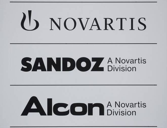 Logos of Swiss drugmaker Novartis and its divisions Sandoz and Alcon are seen at an office building in Rotkreuz
