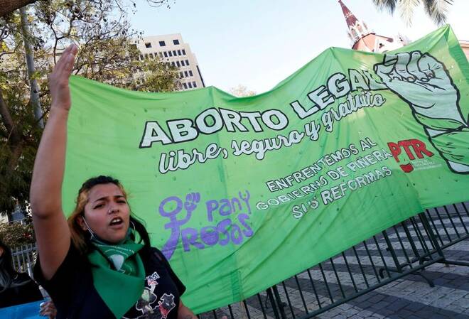Pro-choice activists shout slogans outside Congress, where lawmakers are discussing a bill that decriminalises abortion until the 14th week of gestation, in Valparaiso