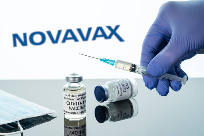 Covid-19 vaccine in vial with syringe reflected against Novavax logo on white background