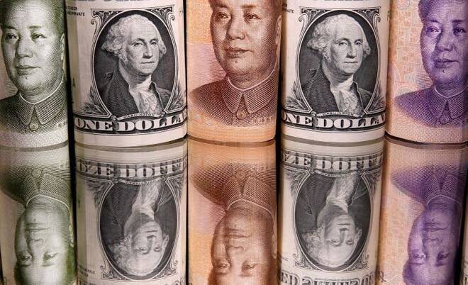 Chinese Yuan and U.S. dollar banknotes are seen in this illustration