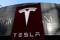 Logo of the electric-vehicle maker Tesla is seen near a shopping complex in Beijing