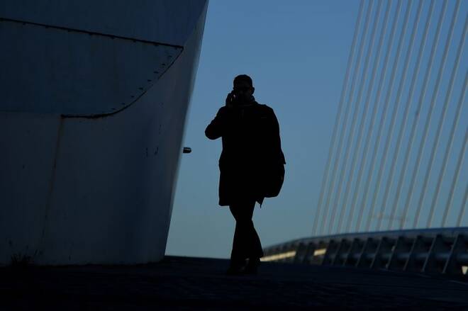 A commuter makes their way into work in the morning in the financial district of Dublin