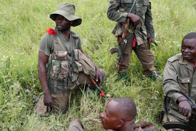 Armed Forces of the Democratic Republic of the Congo (FARDC) soldiers rest next to a road after Islamist rebel group called the Allied Democratic Forces (ADF) attacked area around Mukoko village