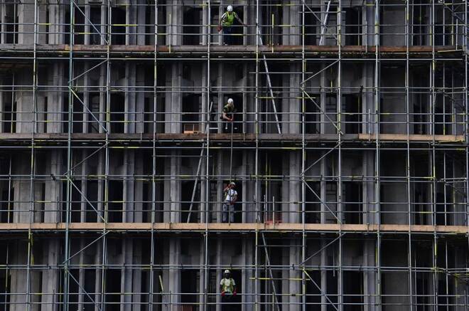 Scaffolders work on a construction site in London