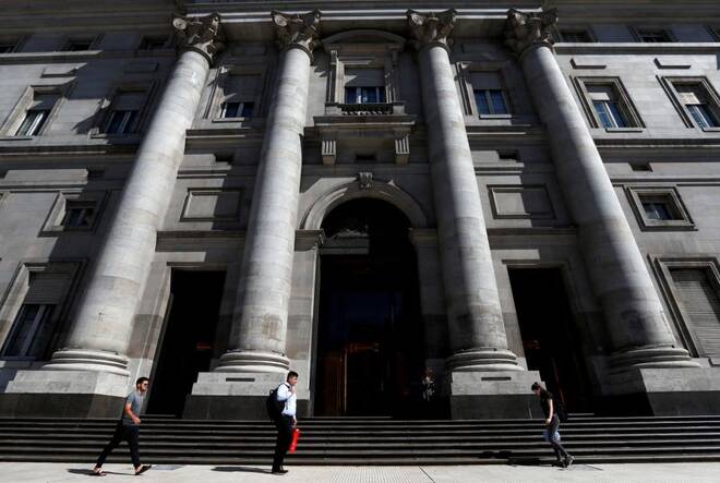Pedestrians walk past the facade of Argentina's Banco Nacion (National Bank), in Buenos Aires