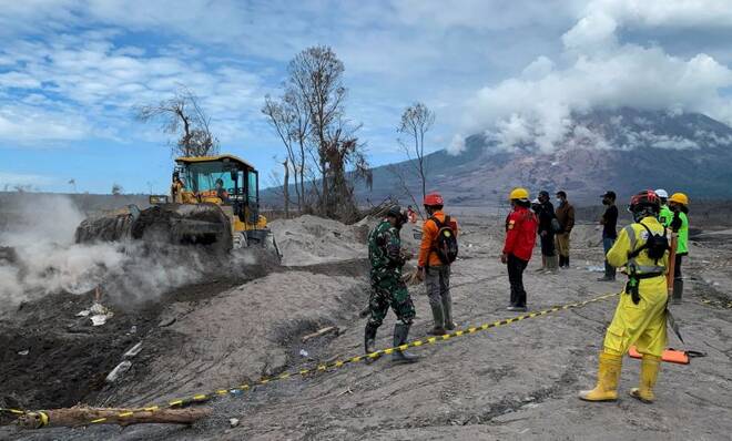 Rescuers use a heavy vehicle during a rescue operation following the eruption of Mount Semeru volcano in Curah Kobokan village, Pronojiwo district, in Lumajang