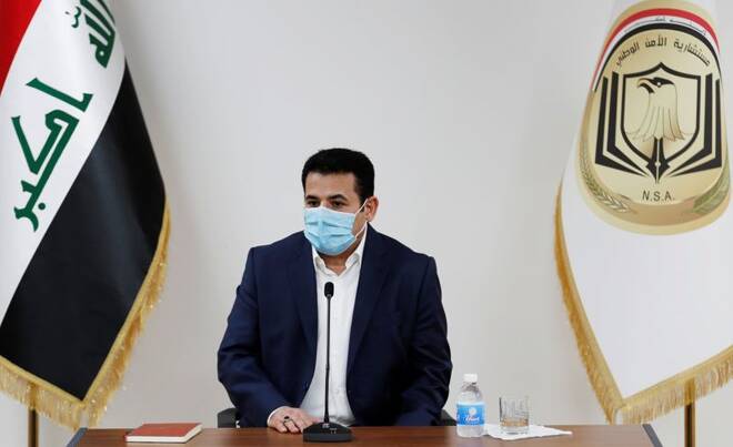 Iraq's National Security Advisor Qasim al-Araji wearing a protective mask speaks after he took up the post from the former security advisor Falih al-Fayyadh in Baghdad