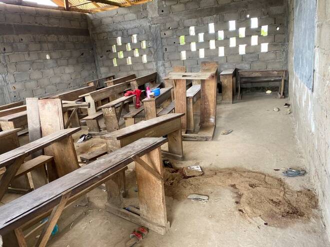 Sand covers a puddle of blood at an empty clasroom following a shooting at a school in Kumba